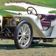 A white American Model 50 Roadster parked at a golf course